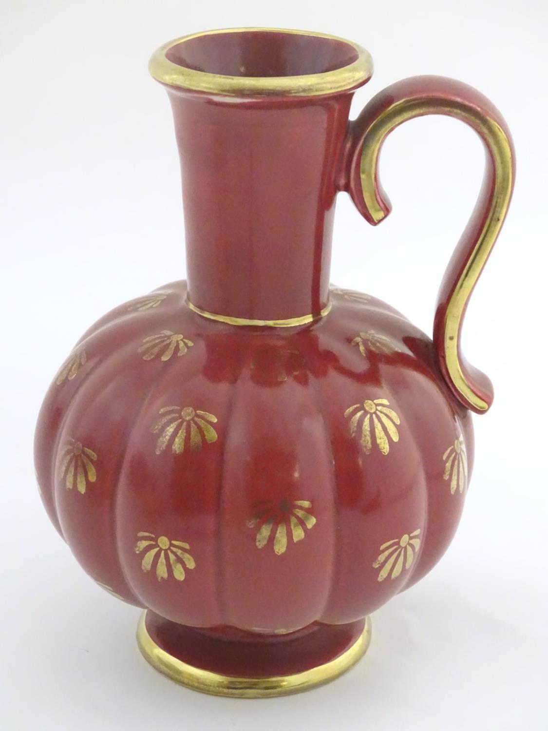 A Swedish single handled vase with a ribbed bulbous body and an elongated neck, with gilt stylised - Image 4 of 7