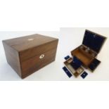 A late Victorian rosewood travelling vanity case, the interior lined in cushioned blue velvet with