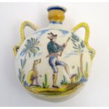 A 19thC Spanish faience pilgrim flask with hand painted decoration depicting a hunting scene and a