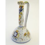 A French faience / maiolica ewer with floral decoration and armorial to the body. Marked 9663
