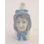 A Royal Worcester figural candle snuffer modelled as Mrs Caudle. Marked within. Approx. 2 3/4"