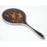 A silver and tortoiseshell hand mirror, hallmarked London 1924, maker Mappin & Webb Ltd. Approx.