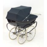 A mid-20thC Marmet coach-built perambulator/pram in navy blue, 53" long, 24" wide, 52" tall Please