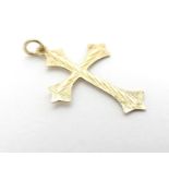 A 9ct gold pendant of cross form with engraved decoration. Approx. 1" long Please Note - we do not