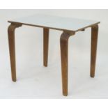 A mid 20thC table with a rectangular top above shaped tapered oak legs. 36" long x 24" wide x 29"