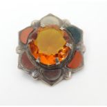 A silver brooch set with various Scottish hardstone agate etc. 1" wide Please Note - we do not