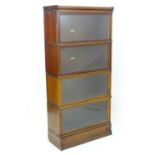 An early / mid 20thC mahogany Globe Wernicke bookcase with four tiers having sliding glass doors.