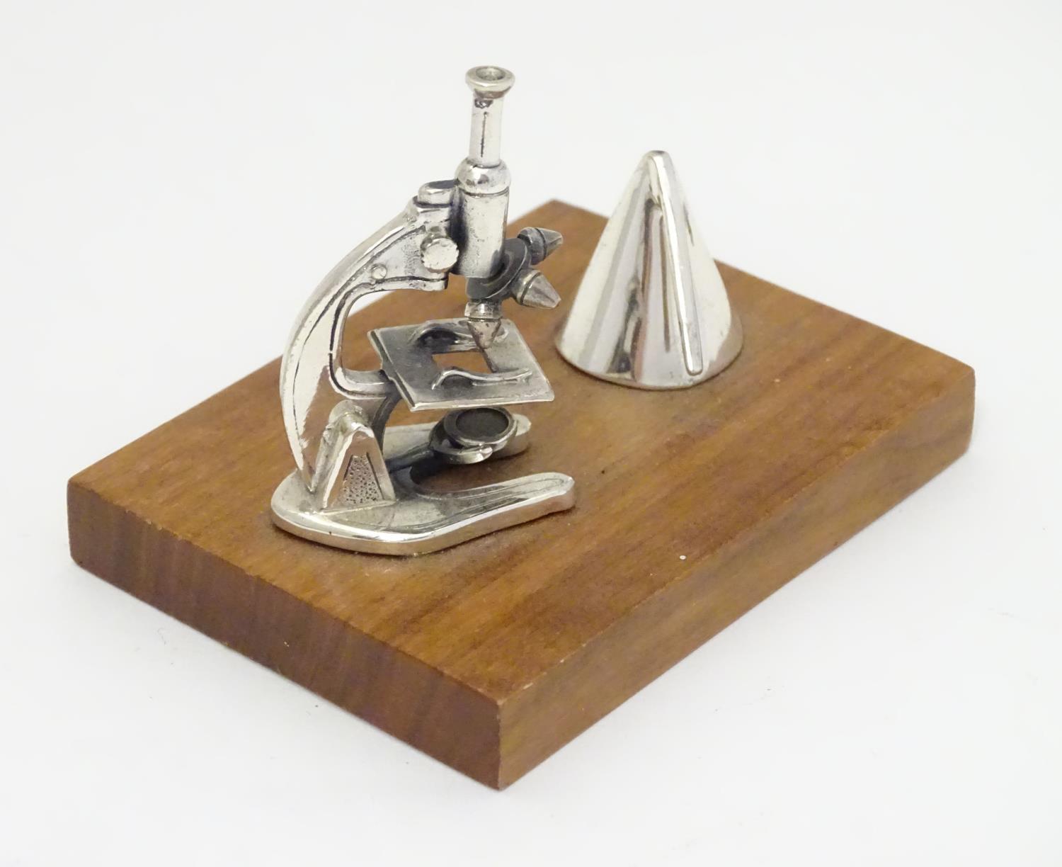 A Continental .925 silver miniature model of a microscope etc. mounted on a wooden base. Approx.