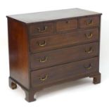 A late 18thC mahogany chest of drawers with a rectangular top above three short over three long