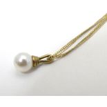 A 9ct gold chain set with yellow metal mounted pearl drop pendant. The chain 18" long Please