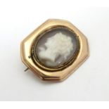 A Victorian cameo brooch, the central cameo behind locket glass within a yellow metal rose gold