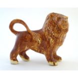 A Paula Humphries Polperro Cornwall studio pottery model of a lion. Marked under paw with