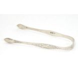 Georgian silver sugar tongs with engraved foliate decoration. Hallmarked London 1810 maker Peter and