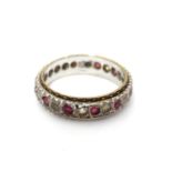 A 9ct white gold eternity ring set with band of red and white stones. Ring size approx N Please Note