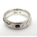 A silver ring set with dark stone. maker DT. Ring size approx L 1/2 Please Note - we do not make