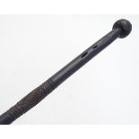 A carved hardwood tribal walking stick / cane, with a carved pommel and carved banded detail to