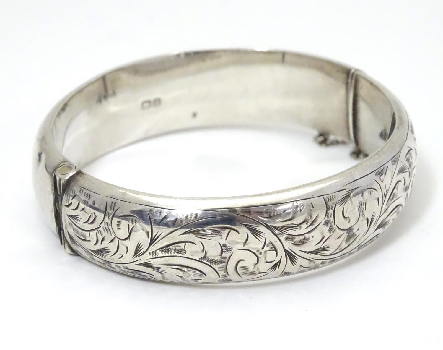 A silver bracelet of bangle form with engraved acanthus scroll decoration. Hallmrked Chester 1952 - Image 4 of 8