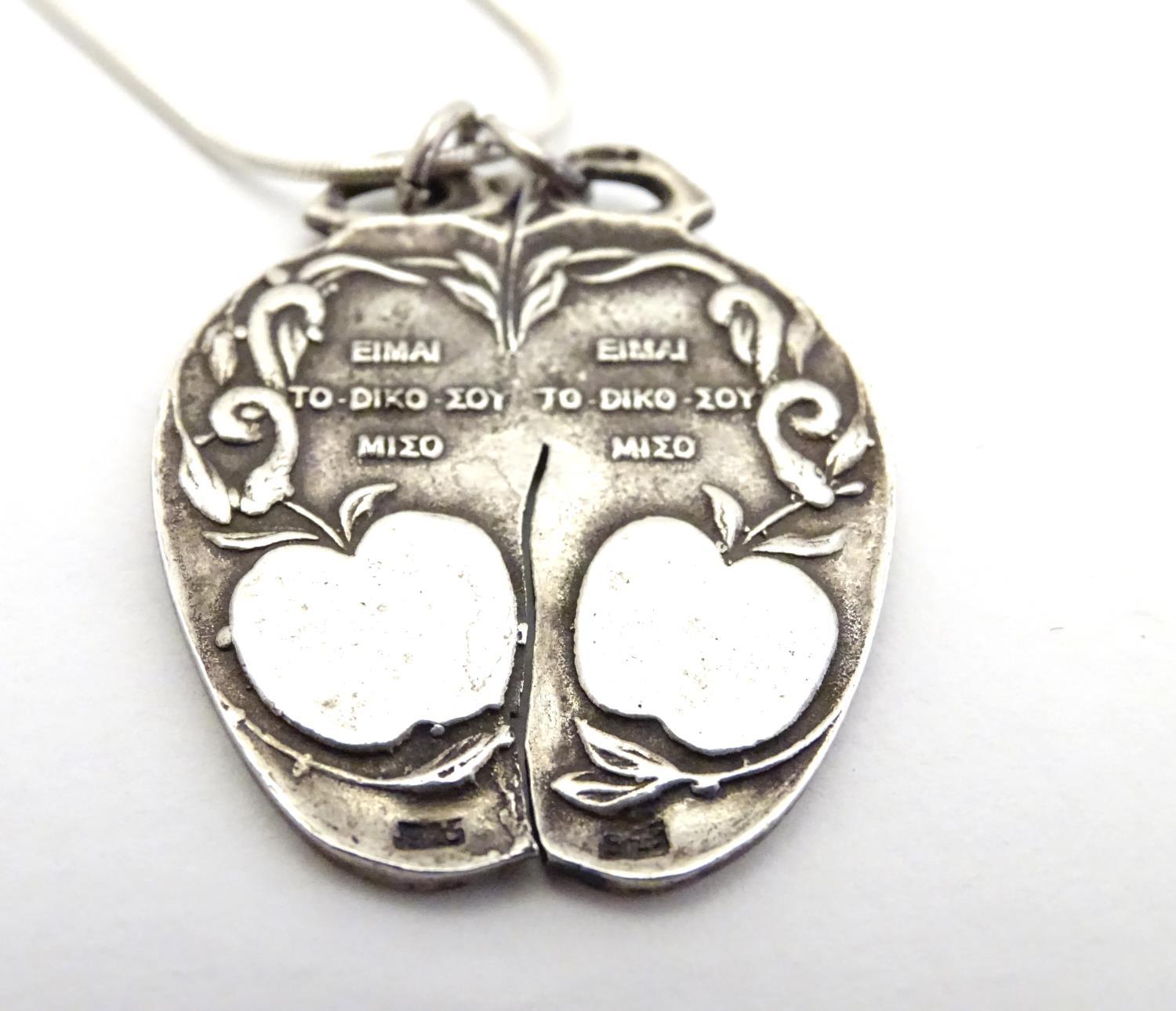 A silver pendant on chain, the pendant formed as an apple with a depiction of Adam and Eve. - Image 5 of 5