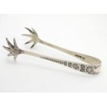 Silver bird?s claw sugar tongs with floral and foliate decoration. Hallmarked Sheffield 1911 maker