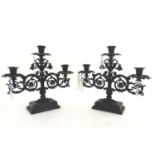 A pair of late-20thC candleabra, of cast iron construction with acanthus styling and provision for