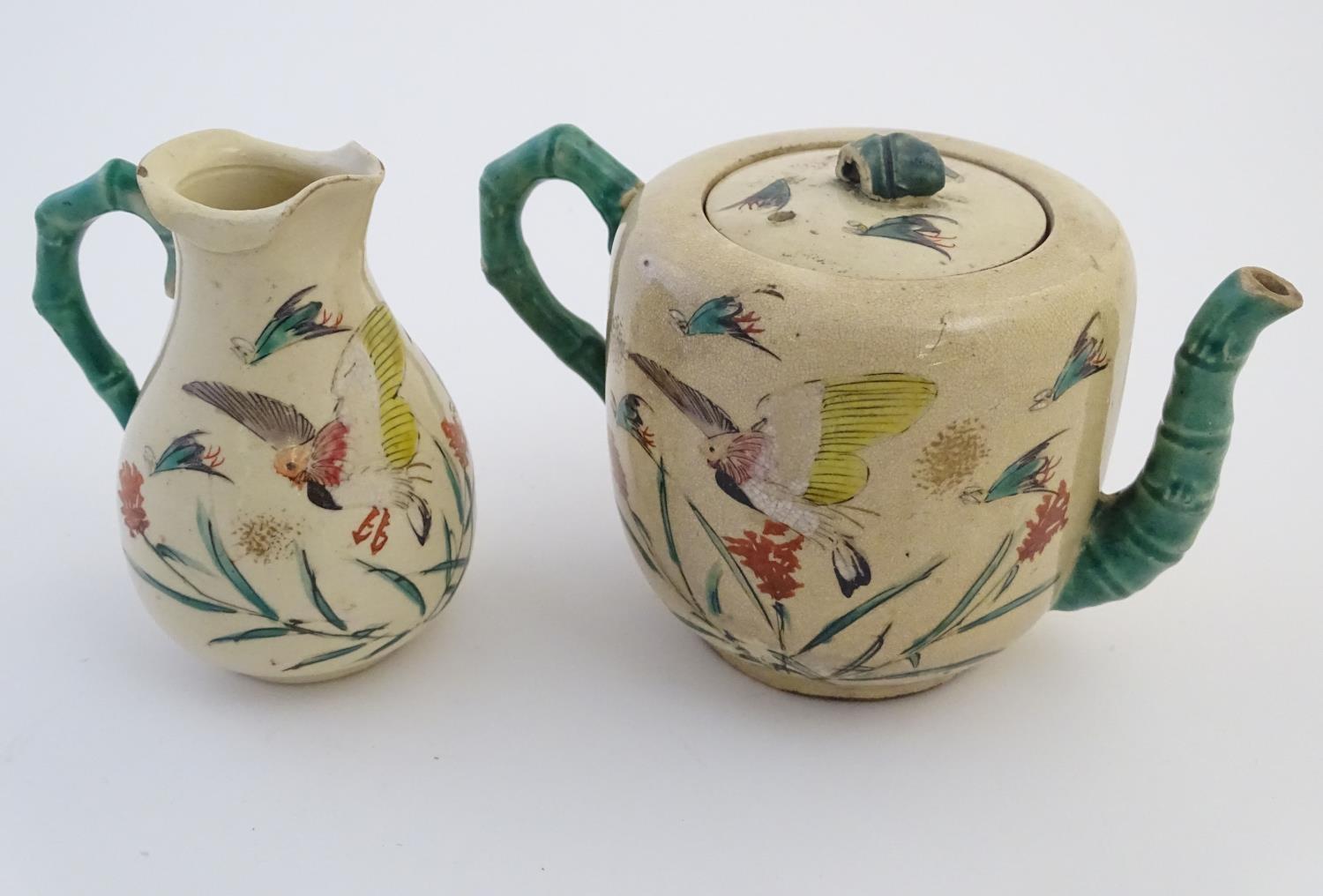 A Japanese teapot and milk jug with hand painted decoration depicting birds and flowers, the handles - Image 3 of 9
