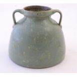A Brannam of Barnstaple twin handled squat vase with a mottled green glaze. Impressed C H Brannam