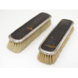 A pair of silver and tortoiseshell backed clothes brushes. Hallmarked Birmingham 1919, maker W. G.