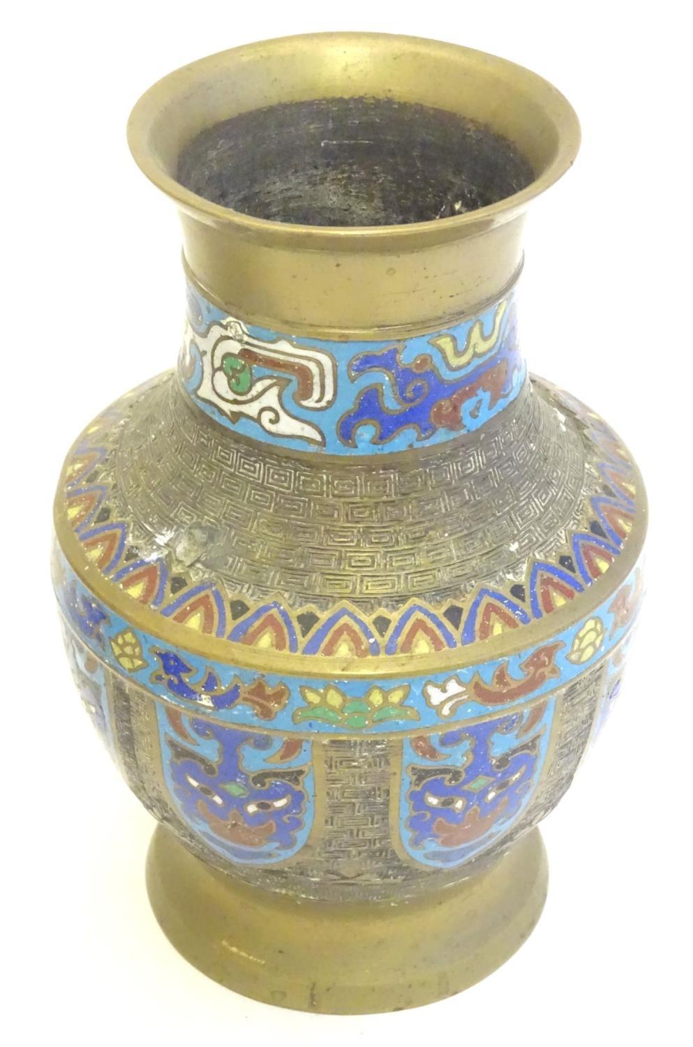 A Japanese brass vase of baluster form with Cloisonné mask and shield decoration to sides. Approx. 9 - Image 3 of 9