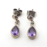 A pair of silver earrings set with amethyst drops 3/4" long Please Note - we do not make reference