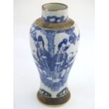 A Chinese blue and white baluster vase depicting figures in a landscape, with incised banded