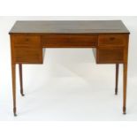 A Georgian mahogany writing desk with a rectangular top above a single long drawer flanked by two