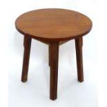A small circular oak side table Please Note - we do not make reference to the condition of lots