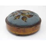 A Victorian walnut footstool of circular form with bead decoration Please Note - we do not make