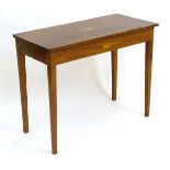 An early 19thC mahogany side table with satinwood cross banding and inlaid marquetry decoration, the