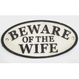 A 21stC painted cast metal oval sign, 'beware of the wife', 7'' wide Please Note - we do not make