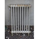 A small cast iron, silver painted Victorian radiator Please Note - we do not make reference to the