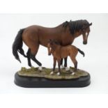 Model of a horse and foal on wooden plinth Please Note - we do not make reference to the condition