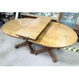 An extended oak pedestal table with 1 leaf and 2 pedestals Please Note - we do not make reference to