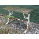 A garden table, with painted cast iron base. Please Note - we do not make reference to the condition