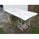 An outdoor garden table the cast base formed from Singer sewing machine table stands Please Note -