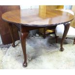 A mahogany circular dining table, extending to an oval with cabriole legs Please Note - we do not