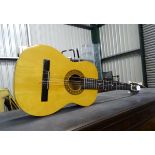 A small acoustic guitar with nylon strings Please Note - we do not make reference to the condition