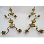 A set of four 20thC wall lights, formed as classical urns with two branches and gilt finish. Each 11