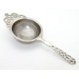 A silver tea strainer hallmarked Birmingham 1930 maker Hammond, Turner & Sons 6 1/2" long Please