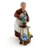 A Royal Doulton figurine depicting an old woman with flowers, Flora, model number 2349. Marked