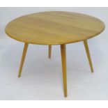 Vintage Retro, Mid-Century: an Ercol elm and beech drop flap dining table, standing on four angled