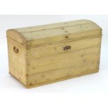 A 19thC pine trunk with a planked dome top, carrying handles and a candle box within. Measuring
