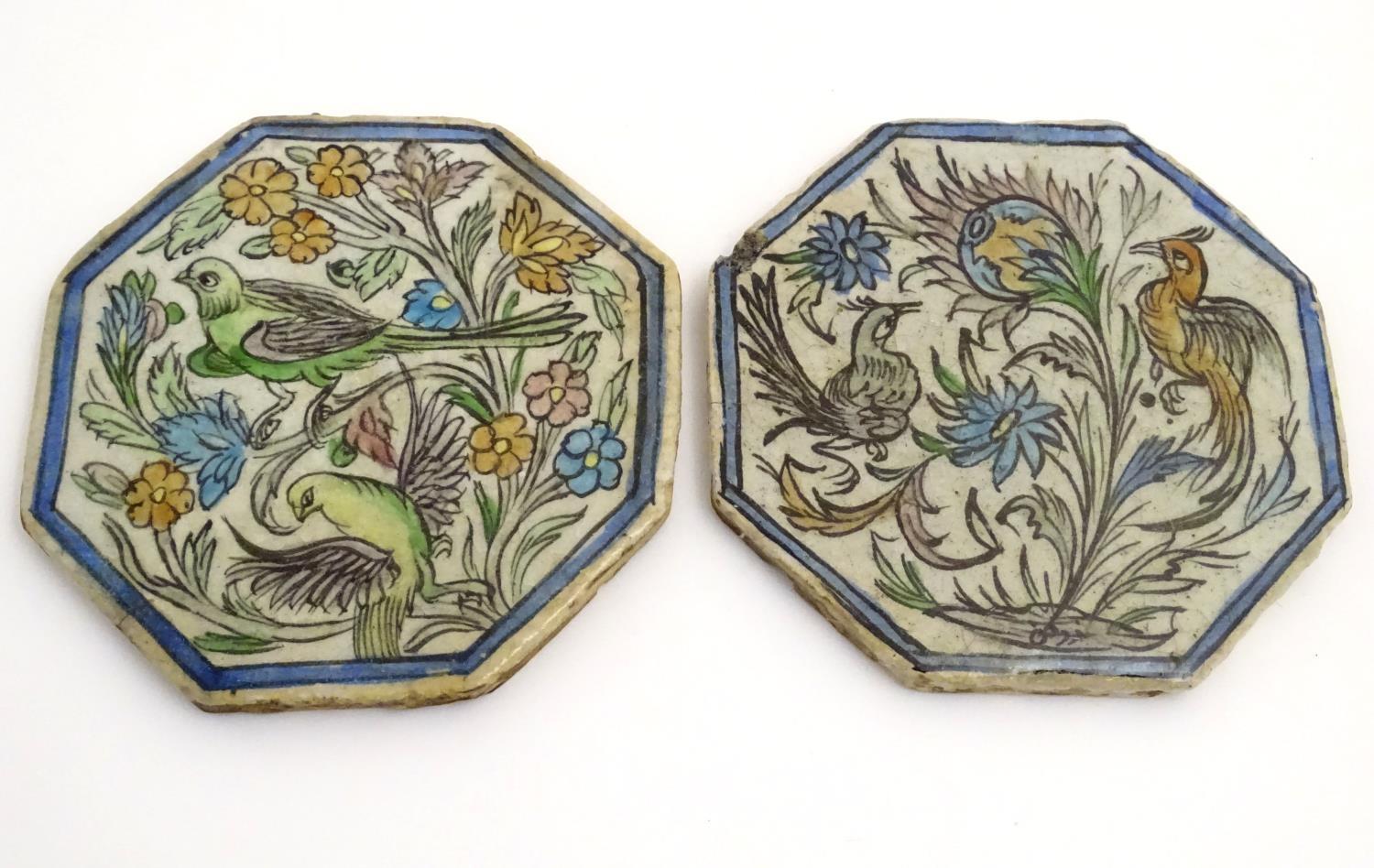 Two Persian tiles of octagonal form decorated with stylised birds and flowers within a blue