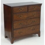 An early 19thC mahogany chest of drawers with a reeded top above two short over three long drawers