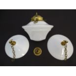 Three early 20thC milk glass lampshades with brass fittings, the largest 10" in diameter (1+2)